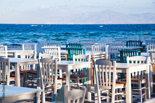 Fototapeta Naklejka Na Ścianę i Meble -  restaurant chairs and tables by the sea