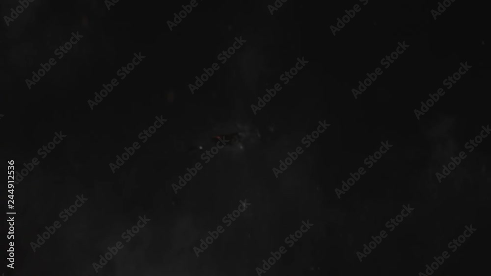 Dusty bullet hit on a wall with chunks of debris flying out. White powder explosion on black background.Impact  dust particles. Dust explosion in front of black background, slow-motion close up.
