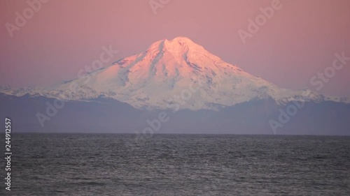 Spectacular view of Cook Inlet overlooking Mount Redoubt during sunrise in Deep Creek State Park in Ninilchik, Alaska photo