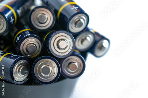 Closeup of pile of used alkaline batteries. Close up colorful rows of selection of AA batteries energy abstract background of colorful batteries. 