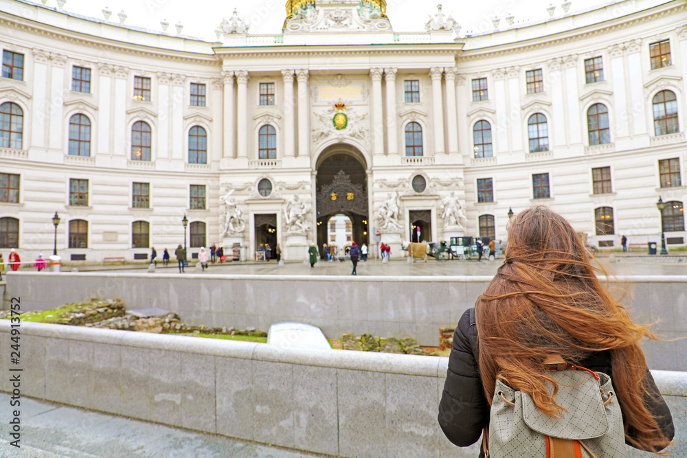 Young female backpacker visiting the Hofburg in winter time, Vienna, Austria
