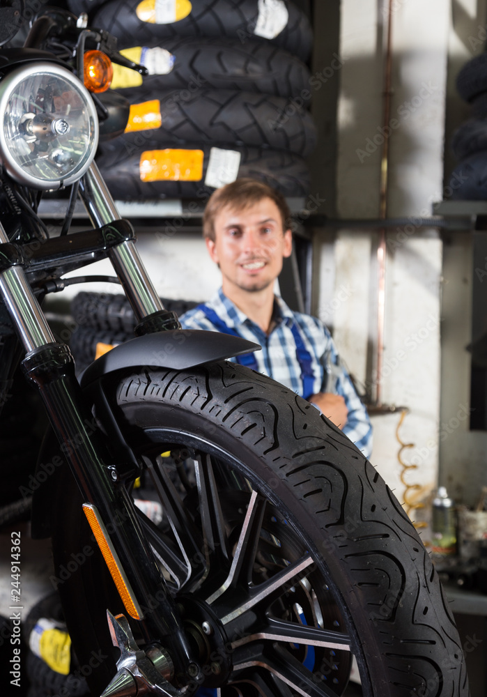young male mechanic working in auto repair shop young male mechanic working in auto repair shop