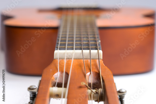 Fretboard of old classical guitar. Stringed musical instrument photo