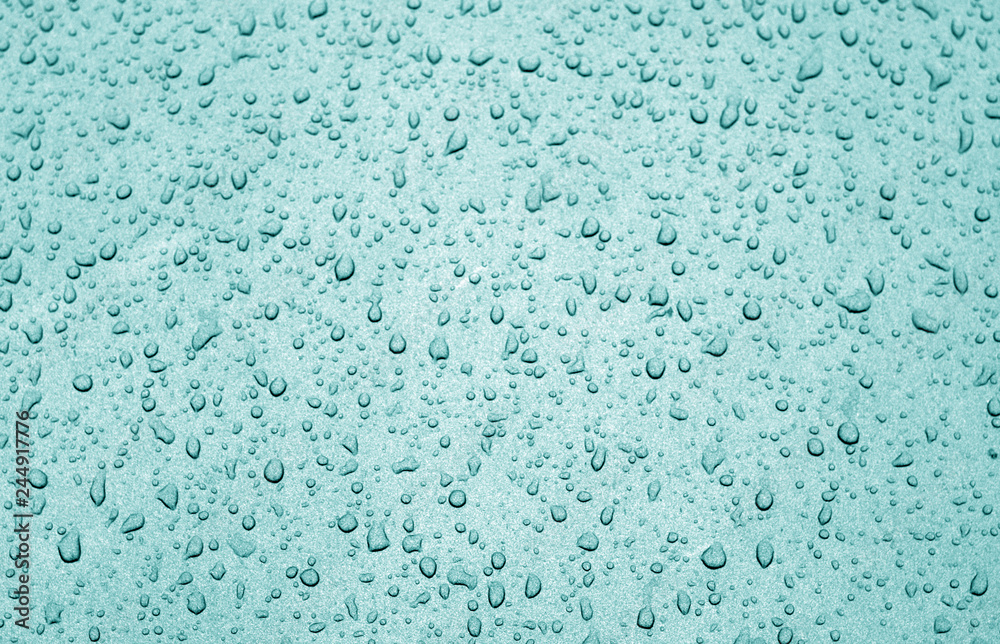 Water drops on car surface in cyan tone. Water drops on car surface in cyan tone.
