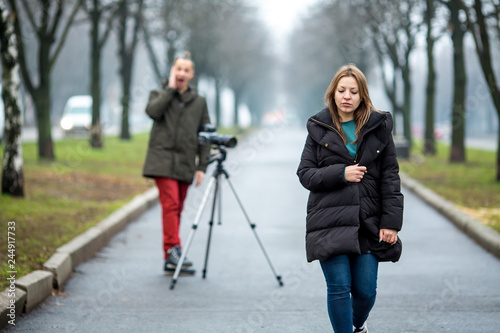 on the wolkway in town a guy takes a picture of a young girl of outdor © gohomespivak