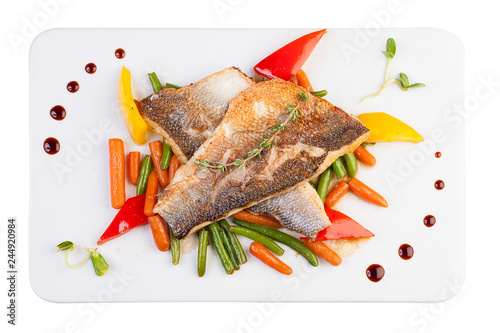 Fillet of sea bass on the vegetables. On white background