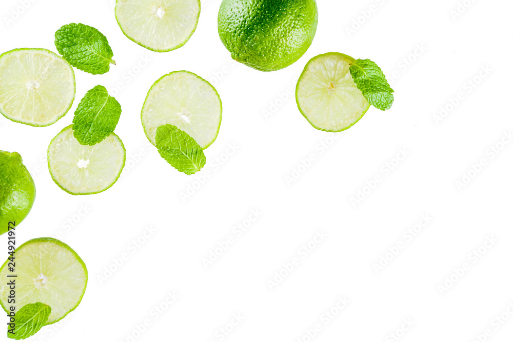 Fresh lime slice with mint leaves isolated on white background, top view copy space. Summer refreshment cocktail ingredient concept.