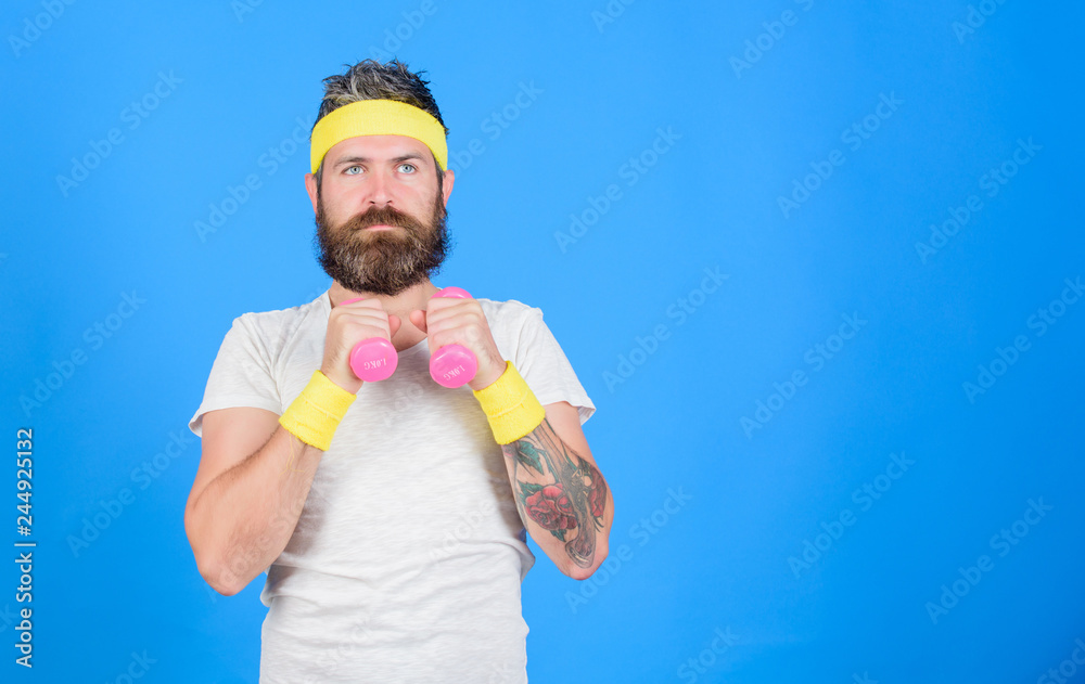 Athlete training with little dumbbell. Man bearded athlete exercising dumbbell. Sportsman retro outfit training blue background. Athlete on way to strong body. Healthy habits. Athlete amateur workout Athlete training with little dumbbell. Man bearded athlete exercising dumbbell. Sportsman retro outfit training blue background. Athlete on way to strong body. Healthy habits. Athlete amateur workout
