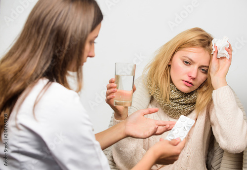 Woman consult with doctor. Girl in scarf hold tissue while doctor offer treatment. Cold and flu remedies. Tips how to get rid of cold. Recognize symptoms of cold. Remedies should help beat cold fast
