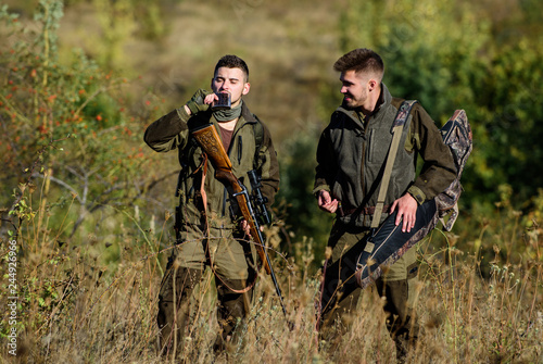 Man hunters with rifle gun. Boot camp. Hunting skills and weapon equipment. How turn hunting into hobby. Military uniform fashion. Friendship of men hunters. Hunter aiming rifle in forest