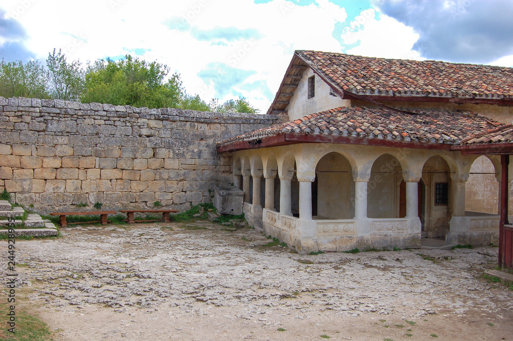 Old houses with tiled roofs. View from the yard. Chufut Kale, a cave city in Crimea from the 5th century