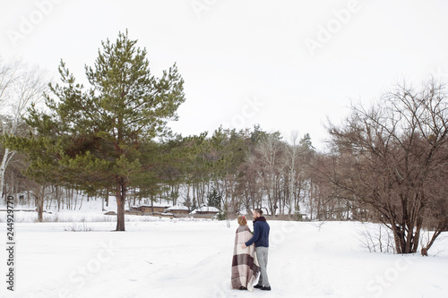 Wedding in winter. Happy couple fun and smile. Bride and groom in the snowy forest in cold winter weather after their wedding ceremony.
