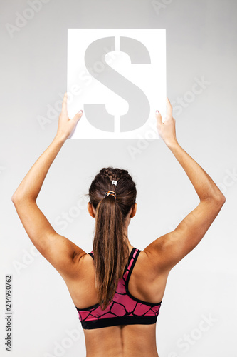 fit girl holding the letter s photo