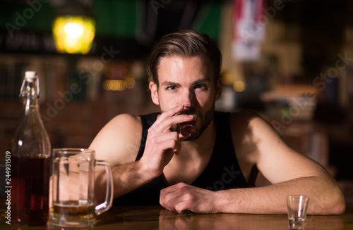 A regular alcohol drinking. Alcohol addict with short alcohol drink. Alcoholic man drinking at bar counter. Man drink strong alcoholic beverage and beer in pub. Alcohol addiction. Drinking alcohol