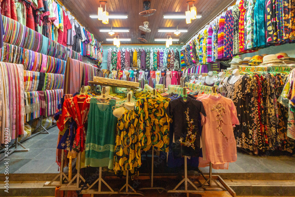 Traditional clothes background at old town shop in Hoi An, the city famous for its history, culture and architecture, Vietnam.