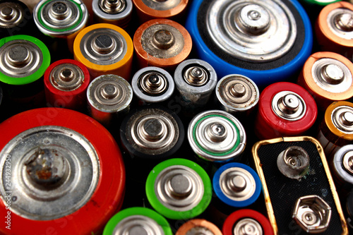 Old electric batteries on black background