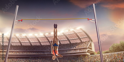 Young female pole vault athlete with pole bar. Women in sport clothes jump over the pole bar at athletic sport track in professional stadium photo