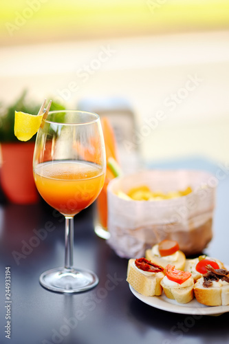 Italian aperitives/aperitif: glass of cocktail (sparkling wine with Aperol) and Fototapeta
