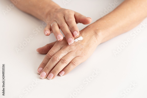 female hands applying an ointment