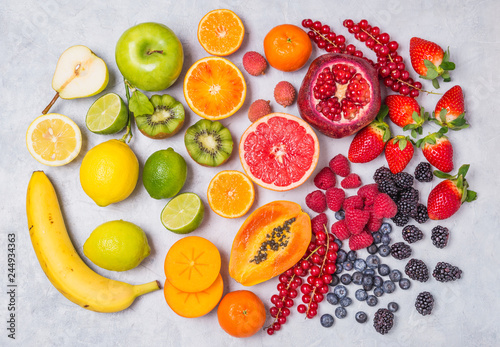 Fruits and berries rainbow colors top view background.Vitamins and antioxidants healthy food concept.