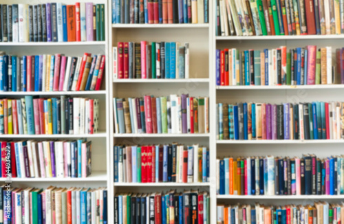 Blurred image of colorful bookshelf In secondhand shop. © Elena Noeva