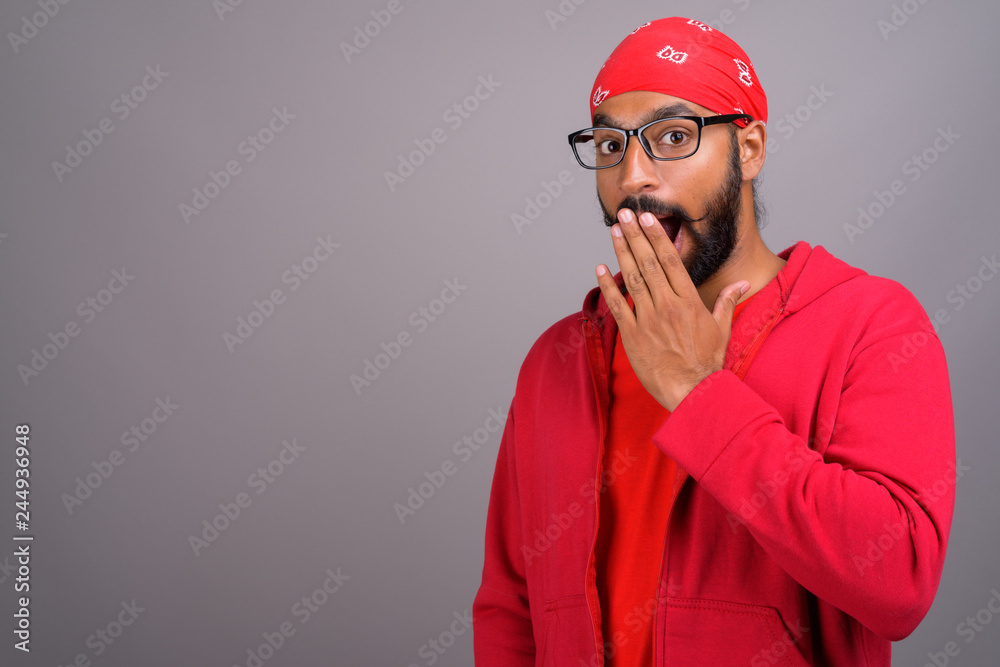 Shocked and surprised Indian man wearing red shirt
