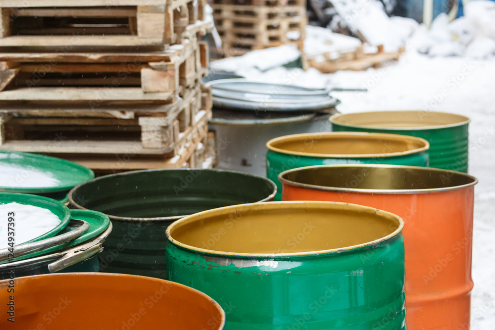Old empty colored tin barrels from gasoline, oil/ vintage cask, rusted tins, cans with chemicals, industry oil barrels, chemical tank, hazardous waste, chemical reagents, ecological concept. Old empty colored tin barrels from gasoline, oil/ vintage cask, rusted tins, cans with chemicals, industry oil barrels, chemical tank, hazardous waste, chemical reagents, ecological concept.