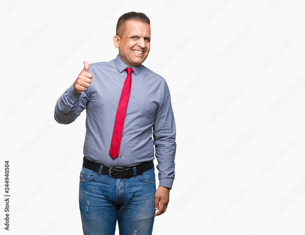 Middle age arab man wearing red tie over isolated background doing happy thumbs up gesture with hand. Approving expression looking at the camera with showing success. Middle age arab man wearing red tie over isolated background doing happy thumbs up gesture with hand. Approving expression looking at the camera with showing success.