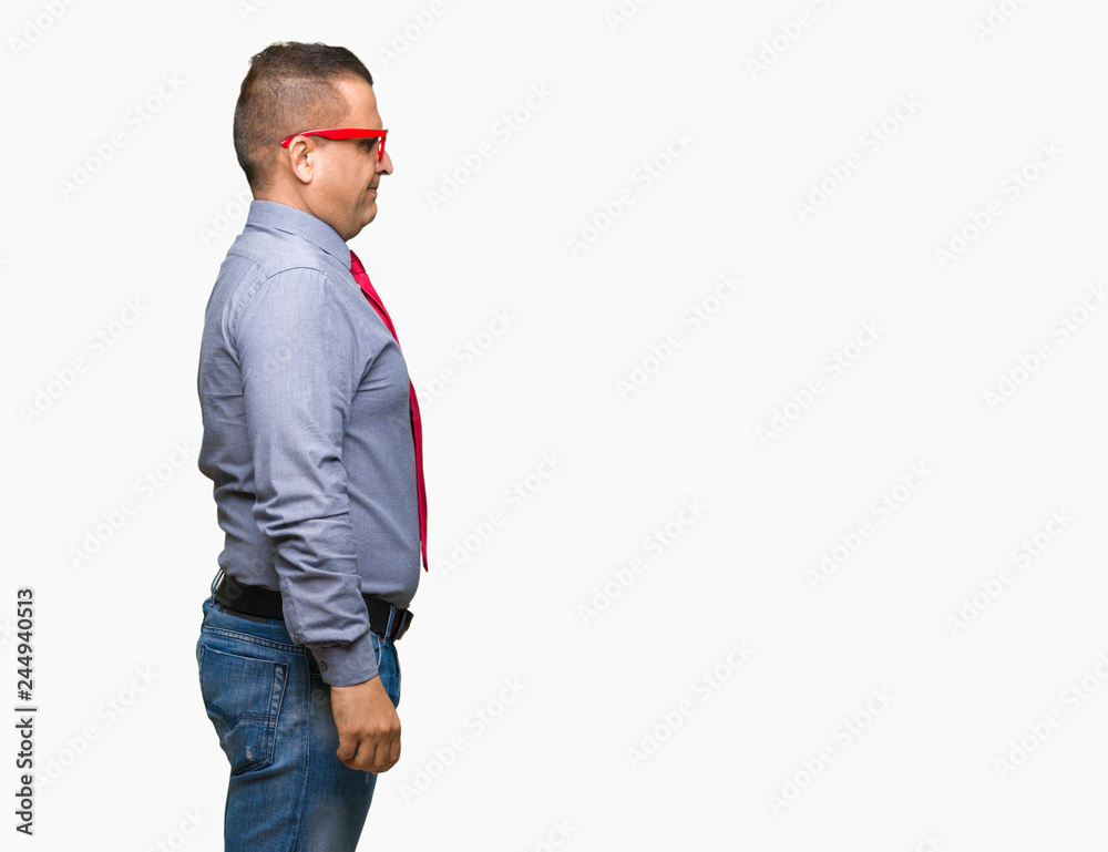 Middle age arab man wearing fashion red glasses over isolated background looking to side, relax profile pose with natural face with confident smile. Middle age arab man wearing fashion red glasses over isolated background looking to side, relax profile pose with natural face with confident smile.