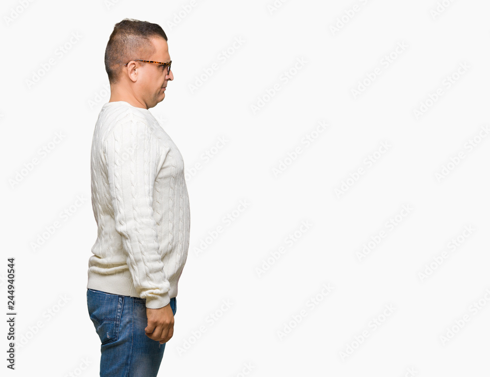 Middle age arab man wearing glasses over isolated background looking to side, relax profile pose with natural face with confident smile. Middle age arab man wearing glasses over isolated background looking to side, relax profile pose with natural face with confident smile.