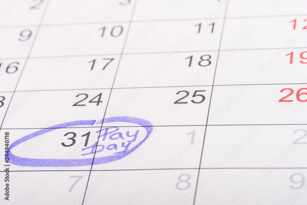selective focus of calendar with marked number 31 and 'pay day' lettering selective focus of calendar with marked number 31 and 'pay day' lettering