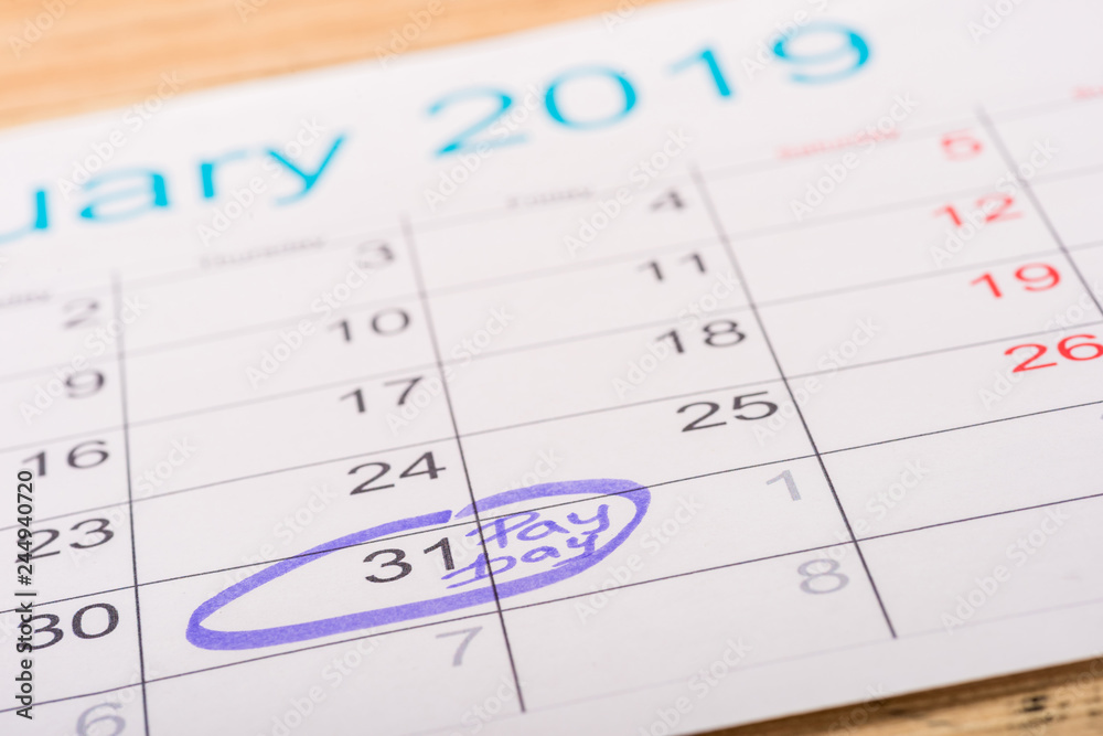 selective focus of calendar with marked number 31 and 'pay day' lettering selective focus of calendar with marked number 31 and 'pay day' lettering