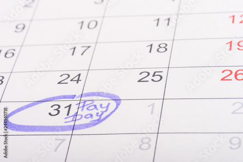 selective focus of calendar with marked number 31 and 'pay day' lettering