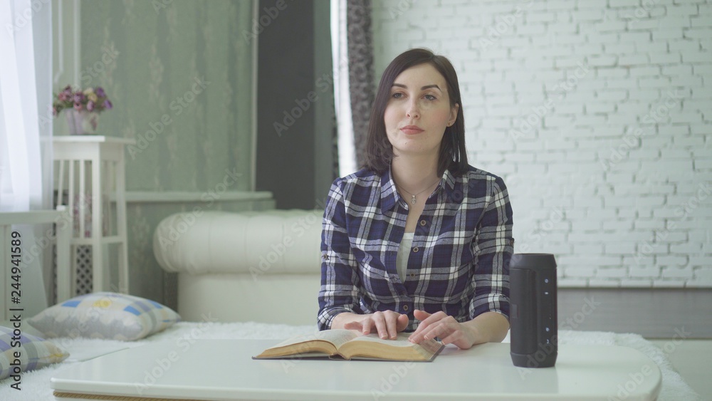 portrait a blind, visually impaired beautiful young woman reads a book, uses a voice portrait a blind, visually impaired beautiful young woman reads a book, uses a voice