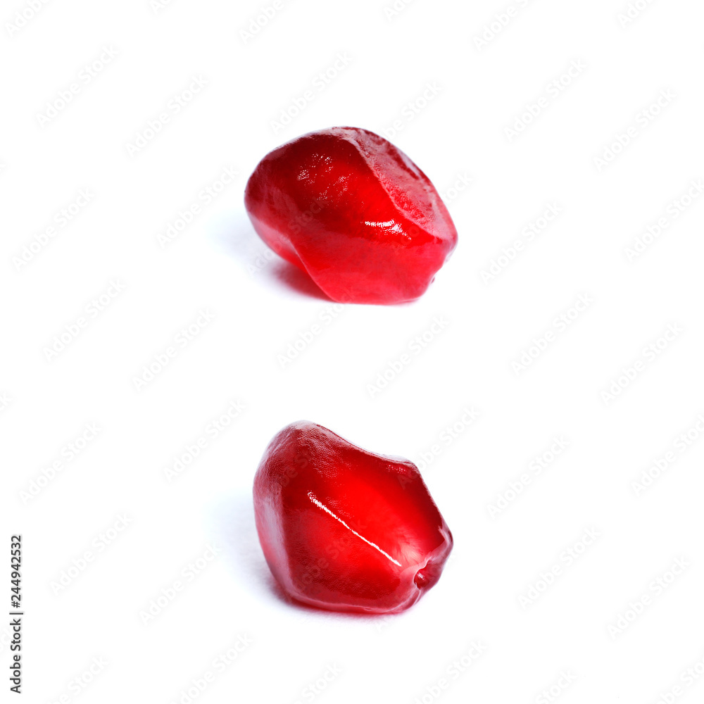 Seeds of a ripe red pomegranate closeup isolated on white background. Seeds of a ripe red pomegranate closeup isolated on white background.