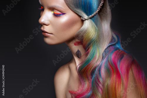 Beautiful girl with multi-colored hair and creative make-up and hairstyle. Beauty face.
