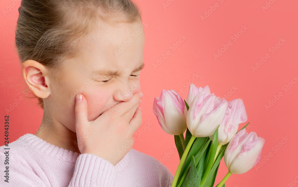 Studio portrait of allergic little girl having an allergic reaction to flowers - tulips, selective focus.