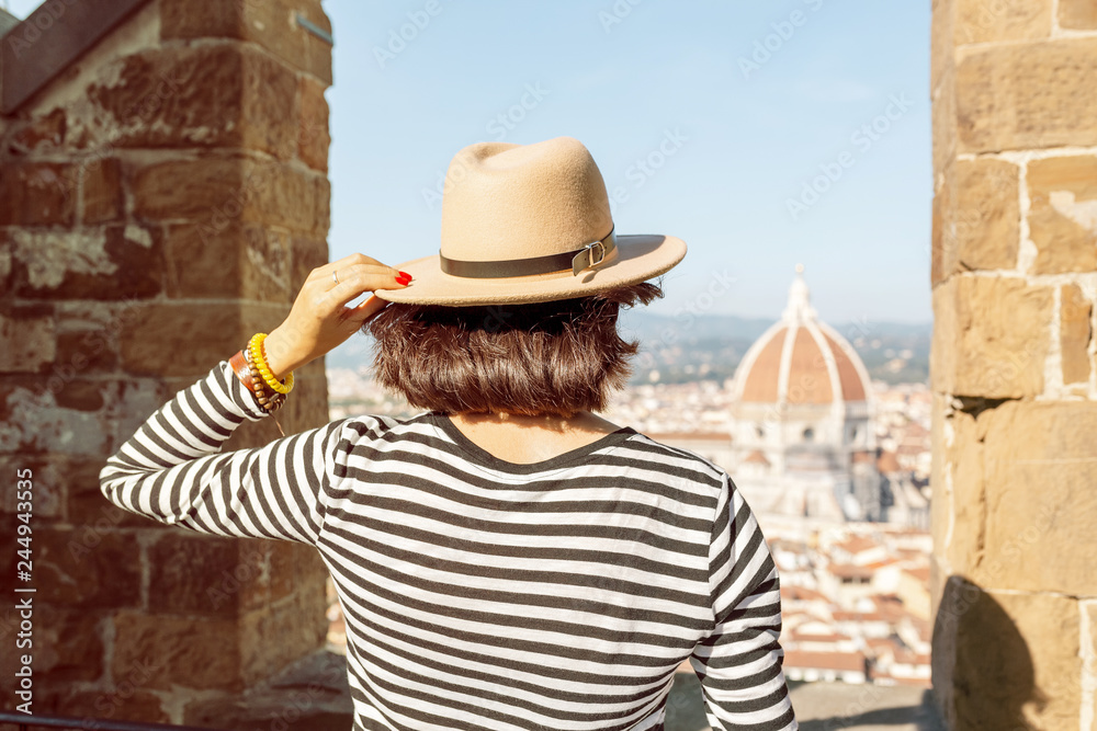 Happy asian tourist woman in the old town of Florence admiring view of the Duomo Cathedral