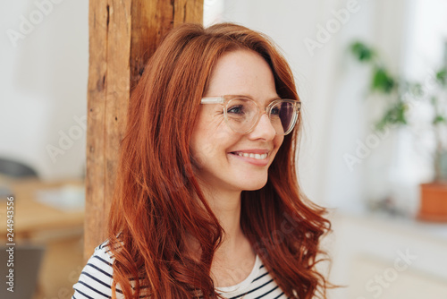 Natural smiling young redhead woman