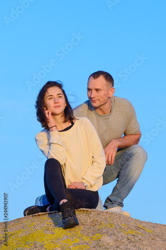 young couple in love on a cliff against the blue sky © sergiy1975