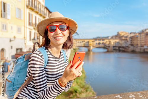 Happy traveler asian women on a vacation in Florence admiring view at the Ponte Vecchio famous landmark during trip in Italy, Europe