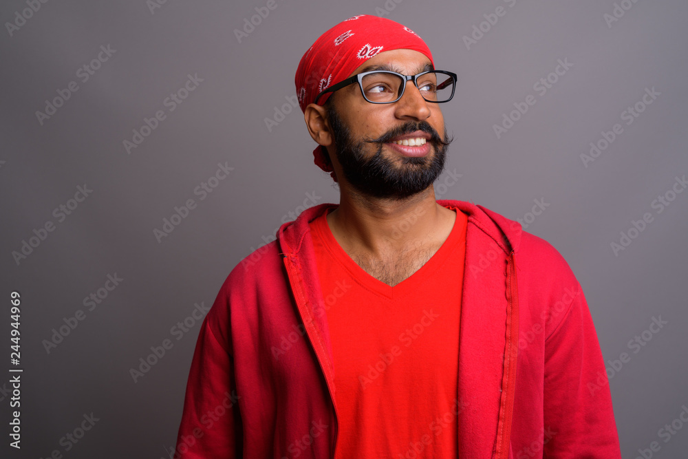 Portrait of happy Indian man thinking and smiling Portrait of happy Indian man thinking and smiling