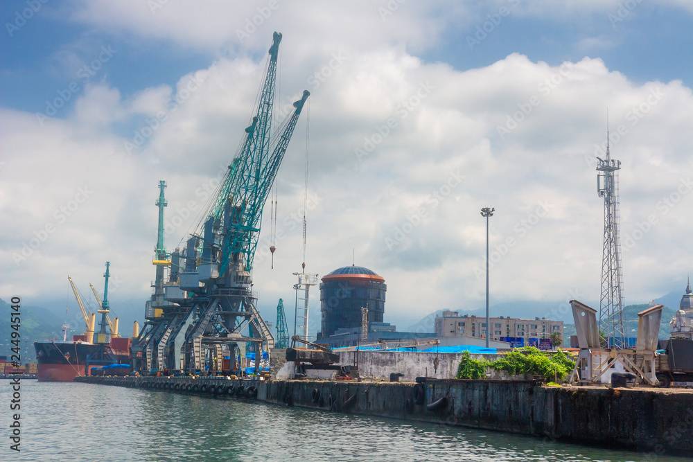 Sea port with cargo cranes. Container terminal in dockyard.