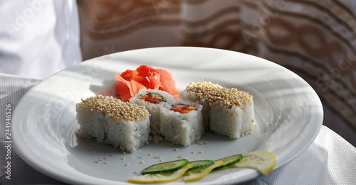 Fotografie Uramaki with red fish, cucumber and white sesame