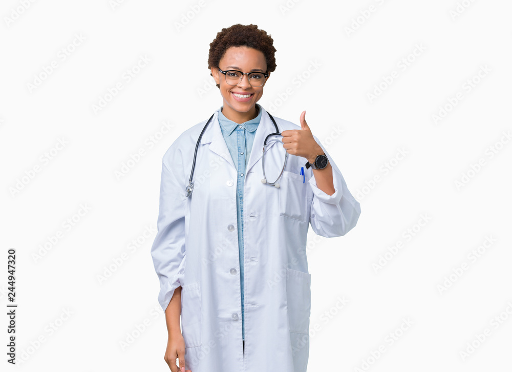 Young african american doctor woman wearing medical coat over isolated background doing happy thumbs up gesture with hand. Approving expression looking at the camera showing success. Young african american doctor woman wearing medical coat over isolated background doing happy thumbs up gesture with hand. Approving expression looking at the camera showing success.