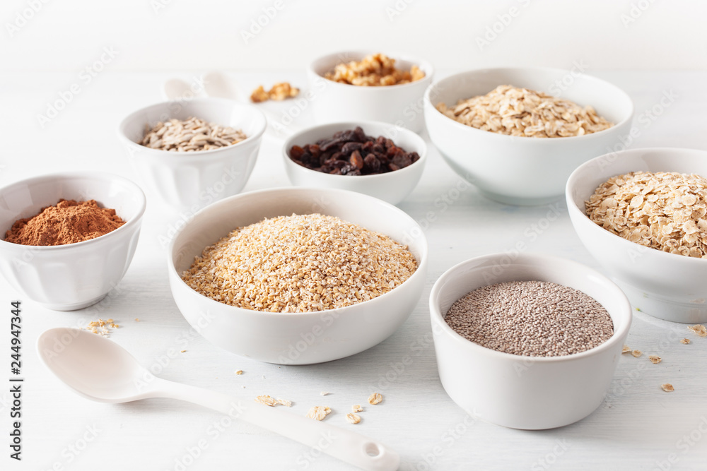 variaty of raw cereals and nuts for breakfast. Oatmeal flakes and steel cut, barley, walnut, chia, raisins. Healthy ingredients variaty of raw cereals and nuts for breakfast. Oatmeal flakes and steel cut, barley, walnut, chia, raisins. Healthy ingredients