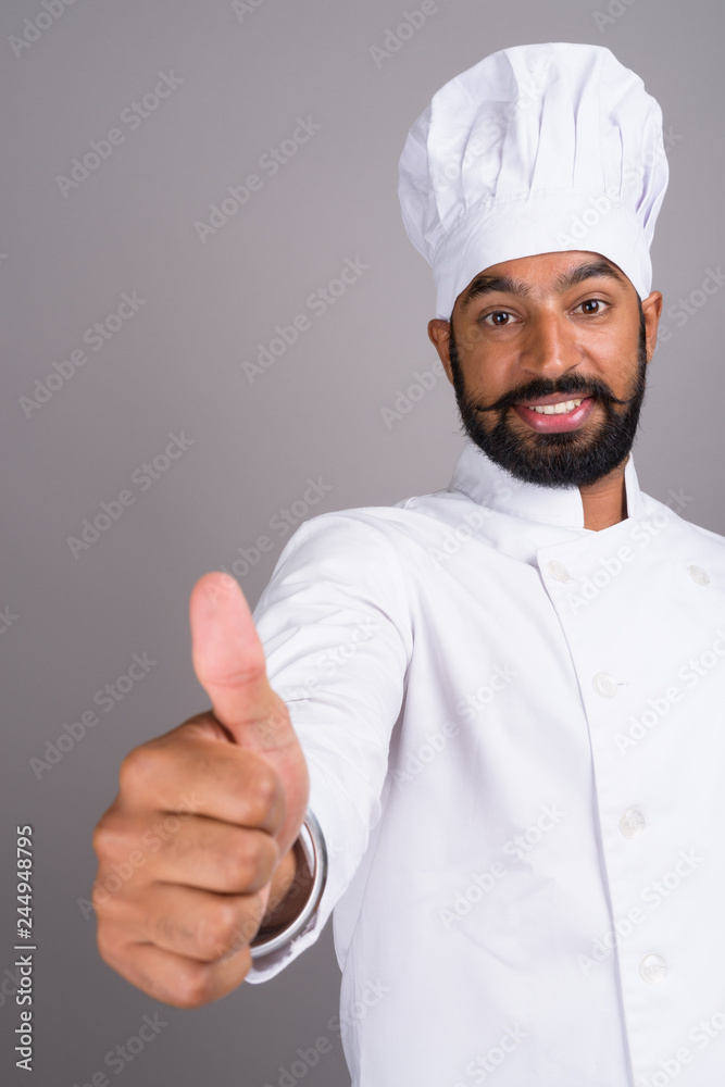 Young handsome Indian man chef giving thumb up Young handsome Indian man chef giving thumb up