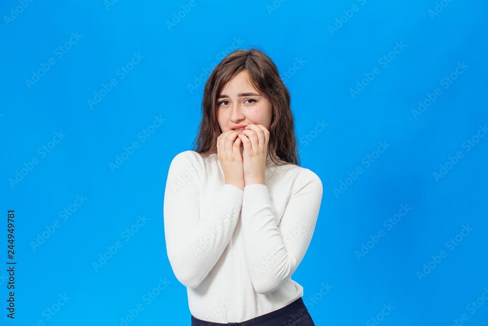 Young beautiful girl isolated on blue background