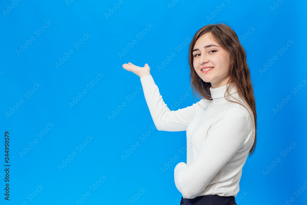 Young beautiful girl isolated on blue background Young beautiful girl isolated on blue background