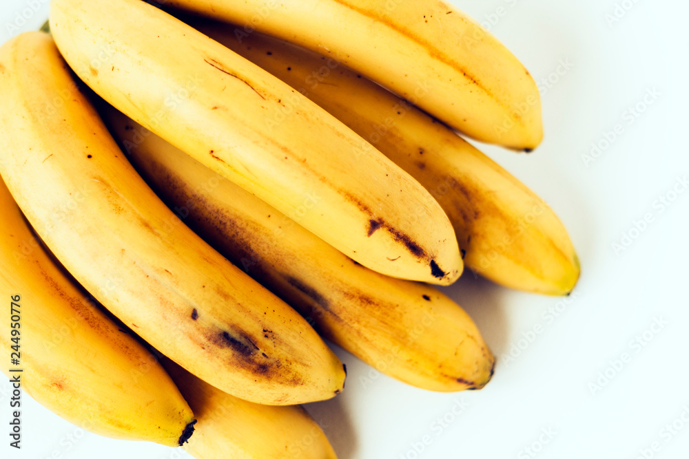 Fresh ripe bananas on white background, vegetarian concept.